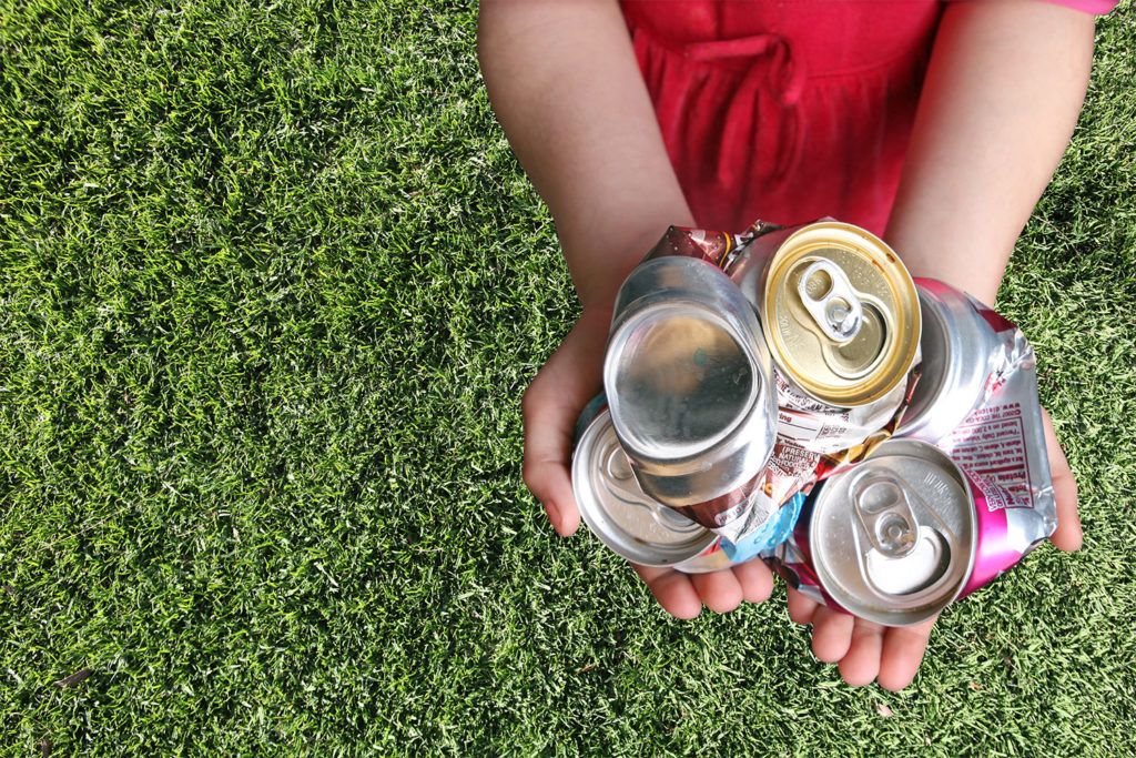Recyclable cans in child's hands